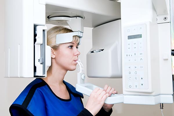Miami Florida dental x-rays - woman in dental office sitting in dental x-ray chair. 