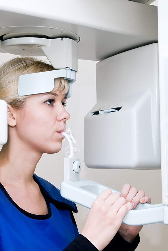 Woman in dental x-ray CBCT scanner